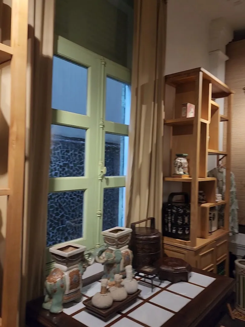 Góc nội thất với cửa sổ, kệ gỗ và các vật trang trí.