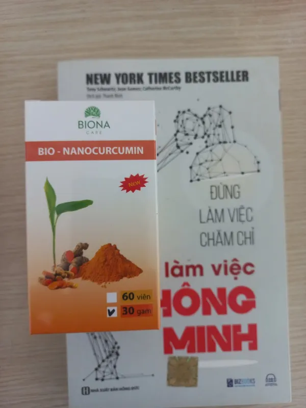 Hộp sản phẩm Biona Care Bio-Nanocurcumin 30 gam đặt trên sách.