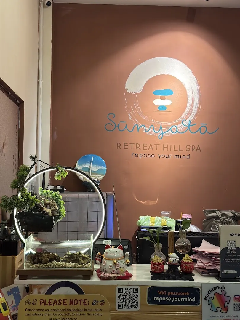 Khu vực quầy lễ tân với logo Sunyata Retreat Hill Spa và các vật trang trí thư giãn.