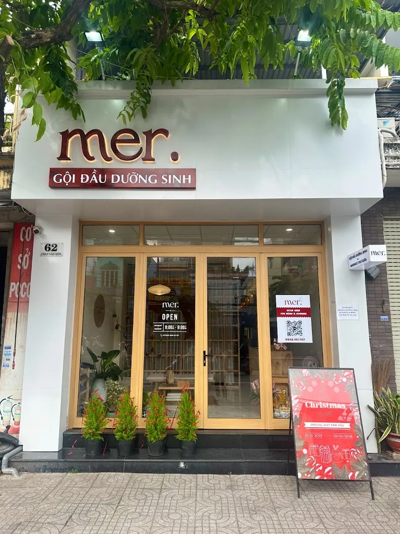 Mặt tiền MER Spa với biển hiệu “Gội đầu dưỡng sinh” và lối vào kính.