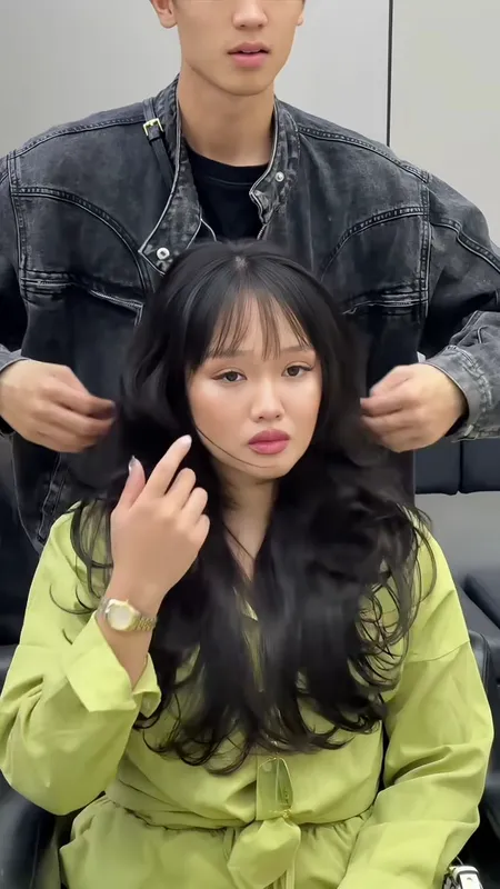 Mẫu tóc dài màu đen với phần mái thưa và uốn gợn sóng.